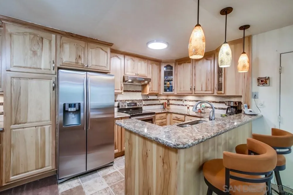 3583 Ruffin Road, Unit 209 San Diego, CA 92123 - Photo 7 of 39 a kitchen with stainless steel appliances granite countertop a sink refrigerator and cabinets