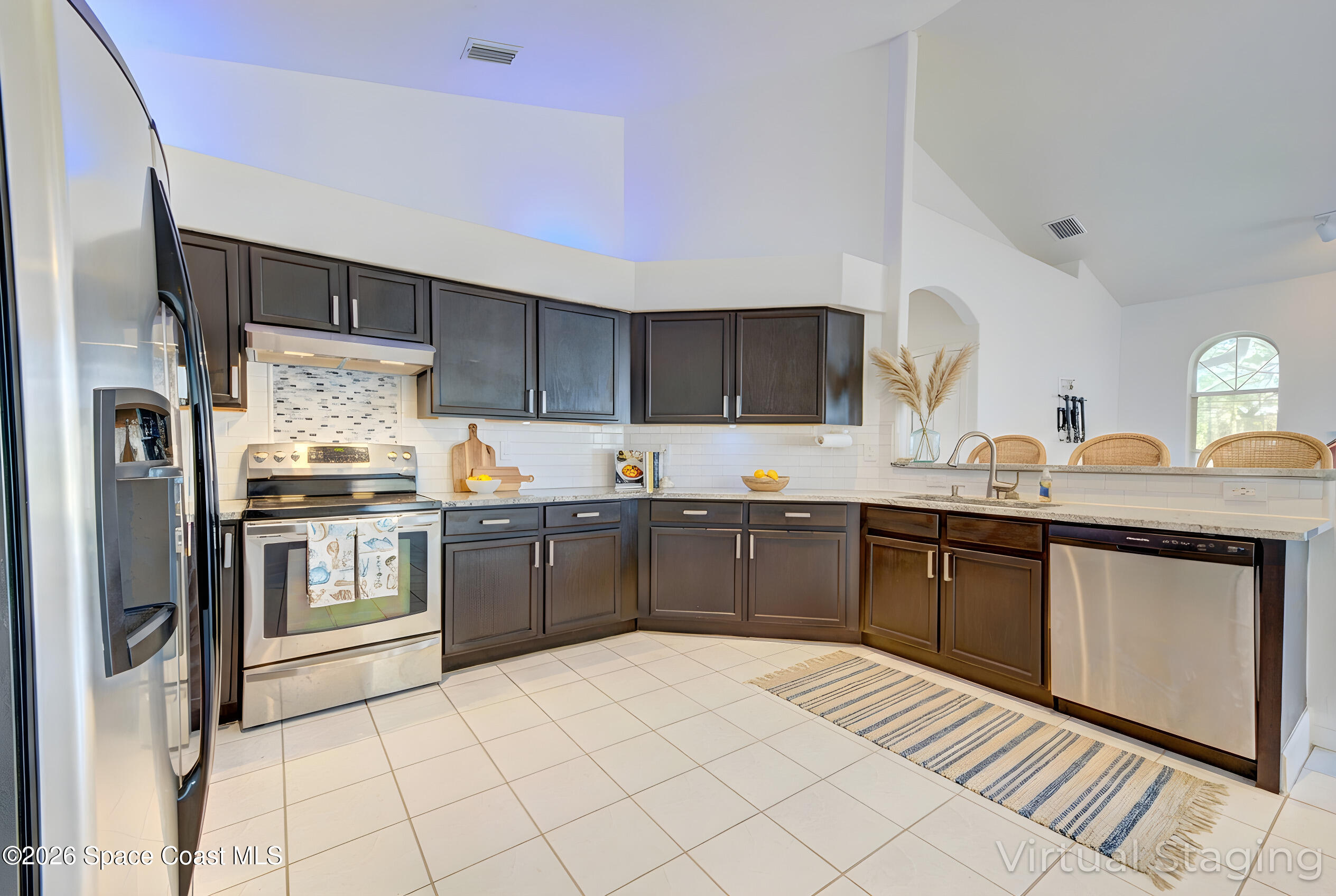 4065 Sand Ridge Drive Merritt Island, FL 32953 - Photo 12 of 59 a kitchen with stainless steel appliances a refrigerator sink and cabinets