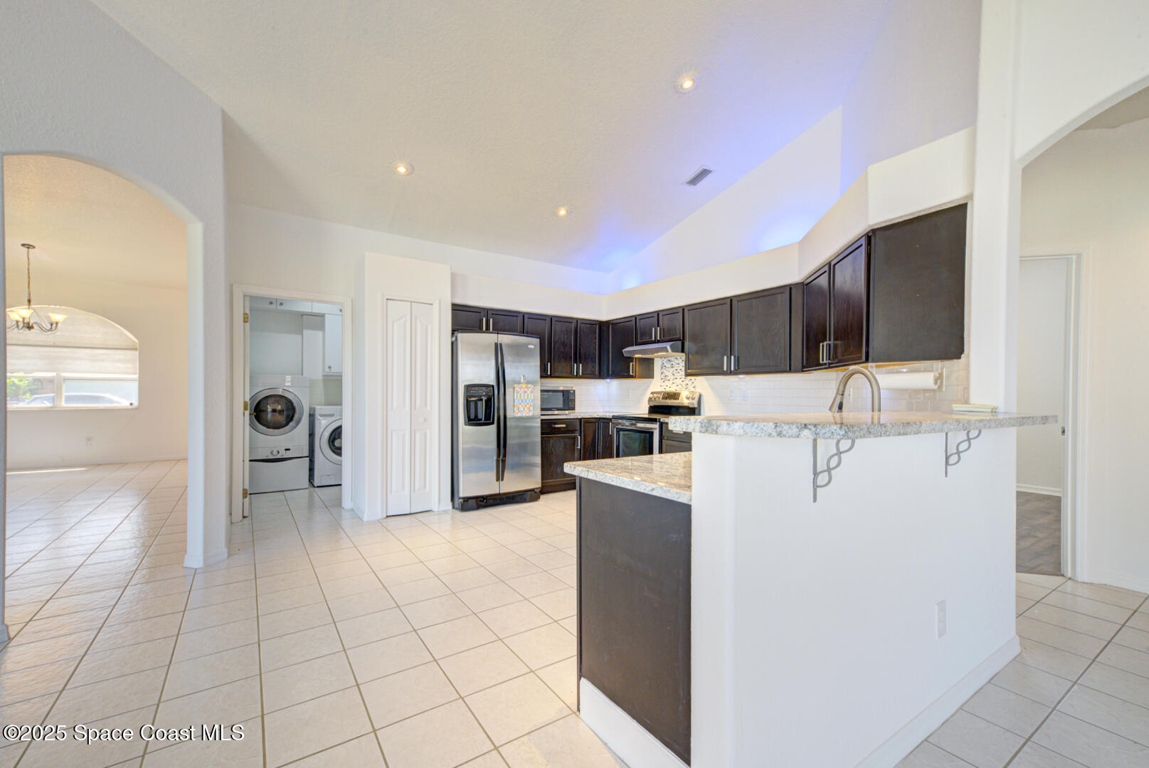 4065 Sand Ridge Drive Merritt Island, FL 32953 - Photo 14 of 59 a view of living room kitchen with stainless steel appliances cabinets