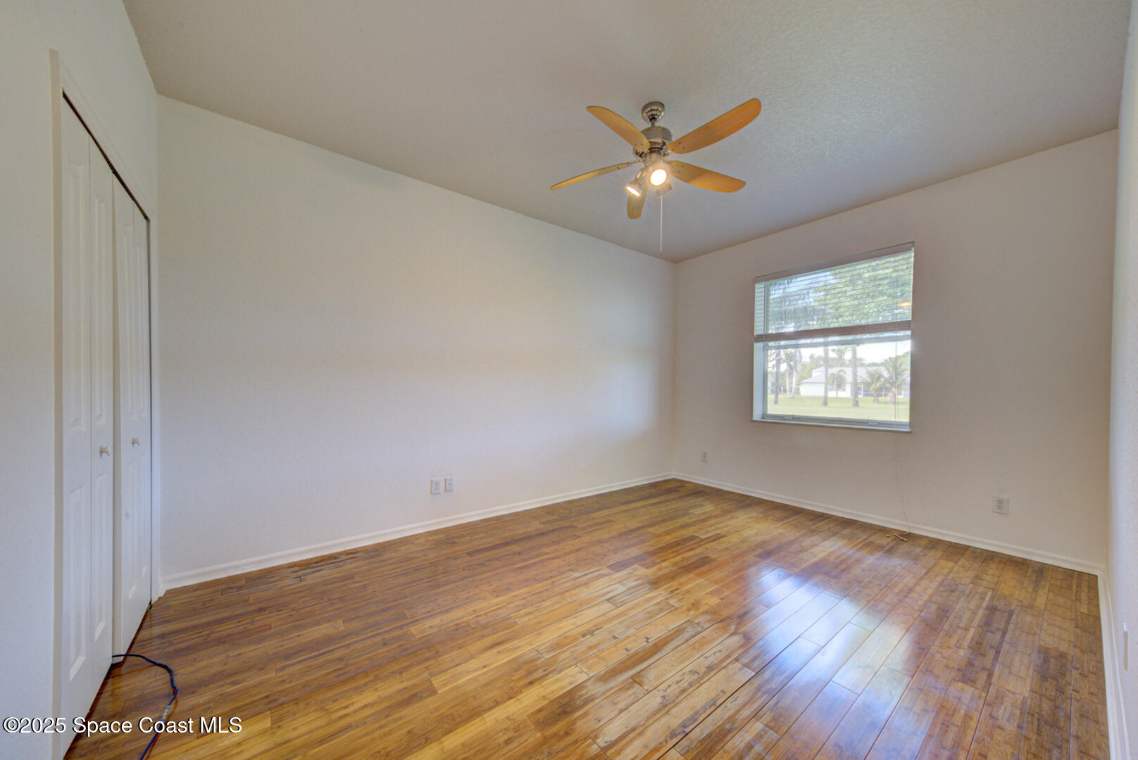 4065 Sand Ridge Drive Merritt Island, FL 32953 - Photo 28 of 59 a view of an empty room with wooden floor and a window
