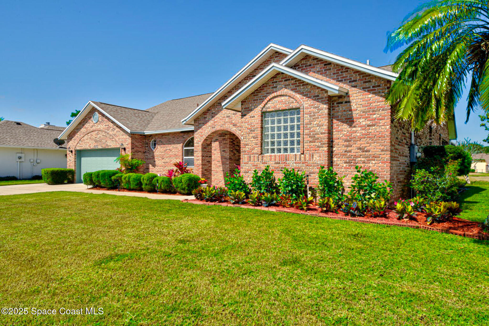 4065 Sand Ridge Drive Merritt Island, FL 32953 - Photo 3 of 59 a front view of a house with a garden