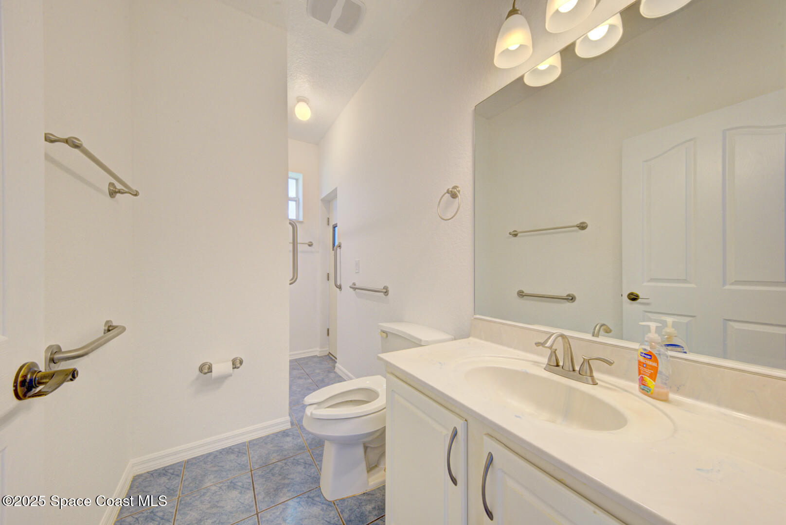 4065 Sand Ridge Drive Merritt Island, FL 32953 - Photo 31 of 59 a bathroom with a sink a toilet and shower