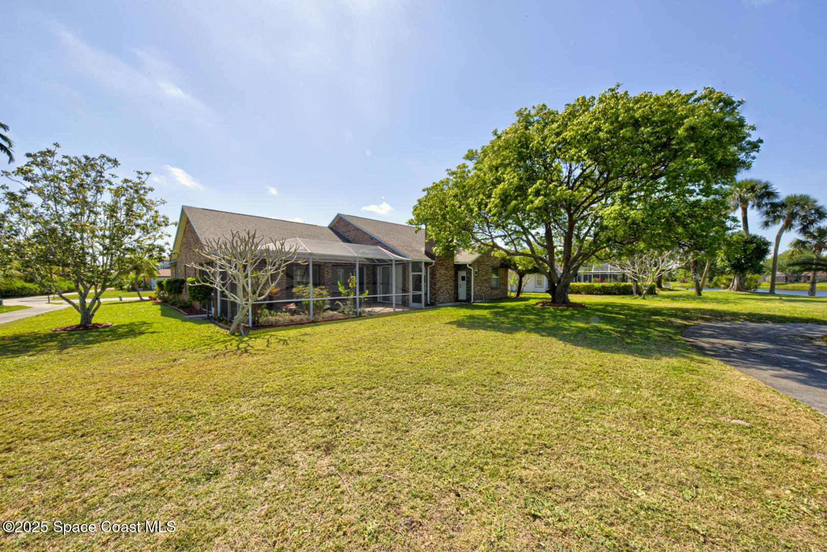 4065 Sand Ridge Drive Merritt Island, FL 32953 - Photo 41 of 59 a swimming pool with trees in the background