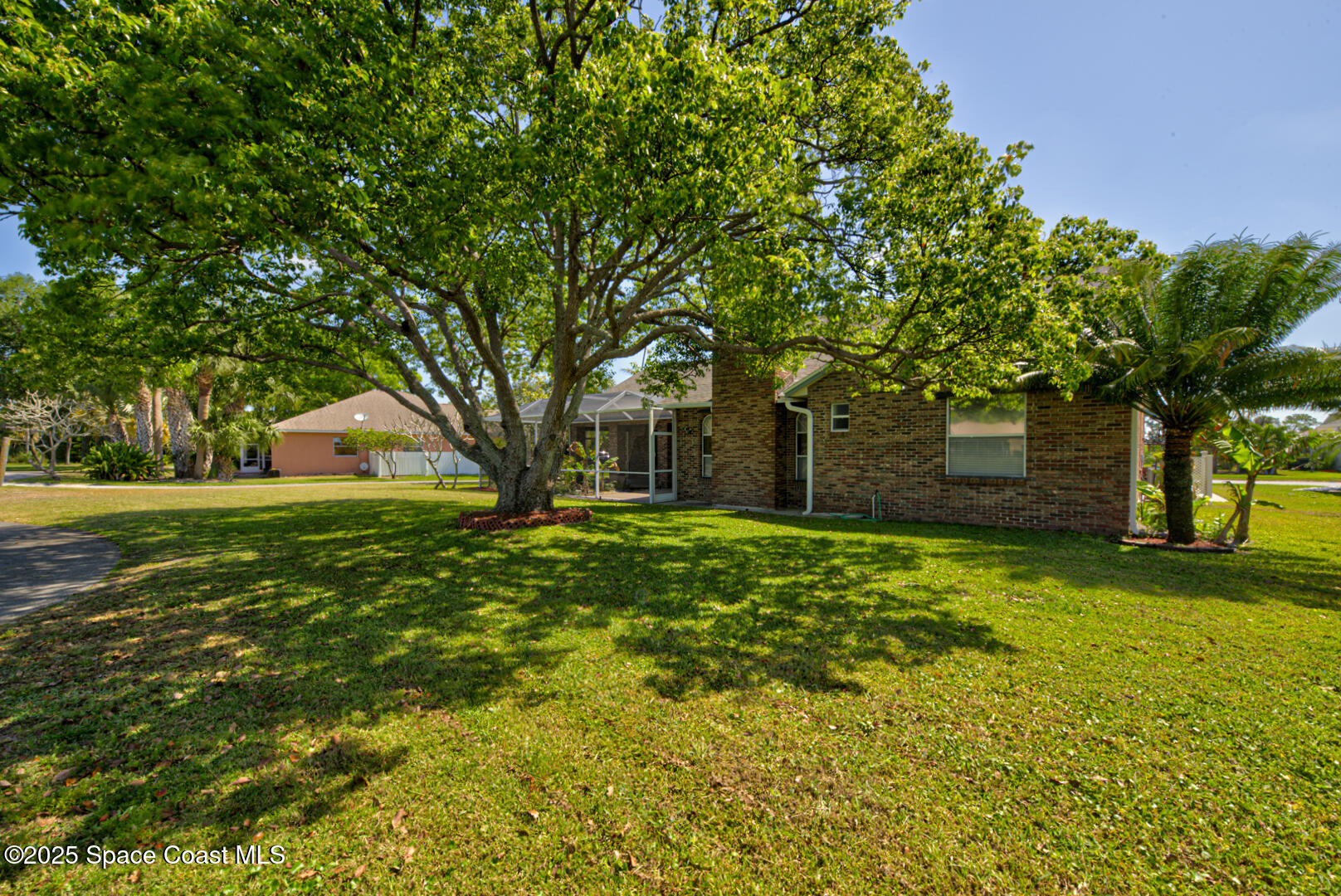 4065 Sand Ridge Drive Merritt Island, FL 32953 - Photo 43 of 59 a front view of a house with garden