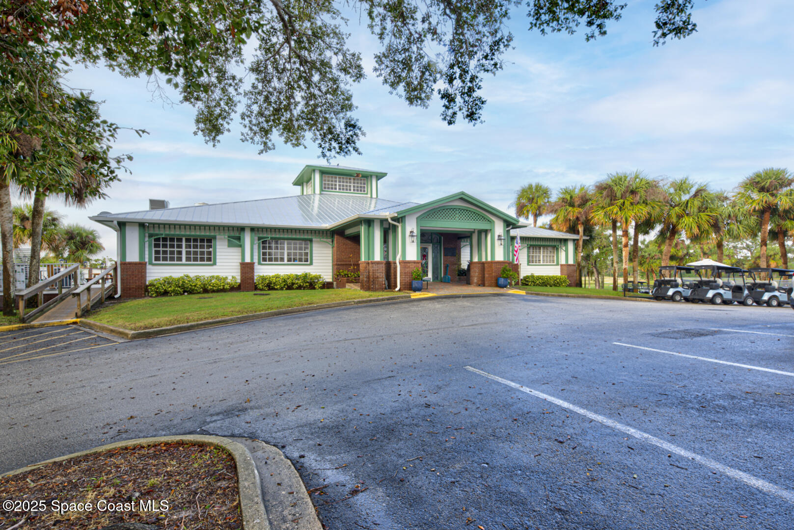 4065 Sand Ridge Drive Merritt Island, FL 32953 - Photo 52 of 59 a view of a white house with a big yard and large trees