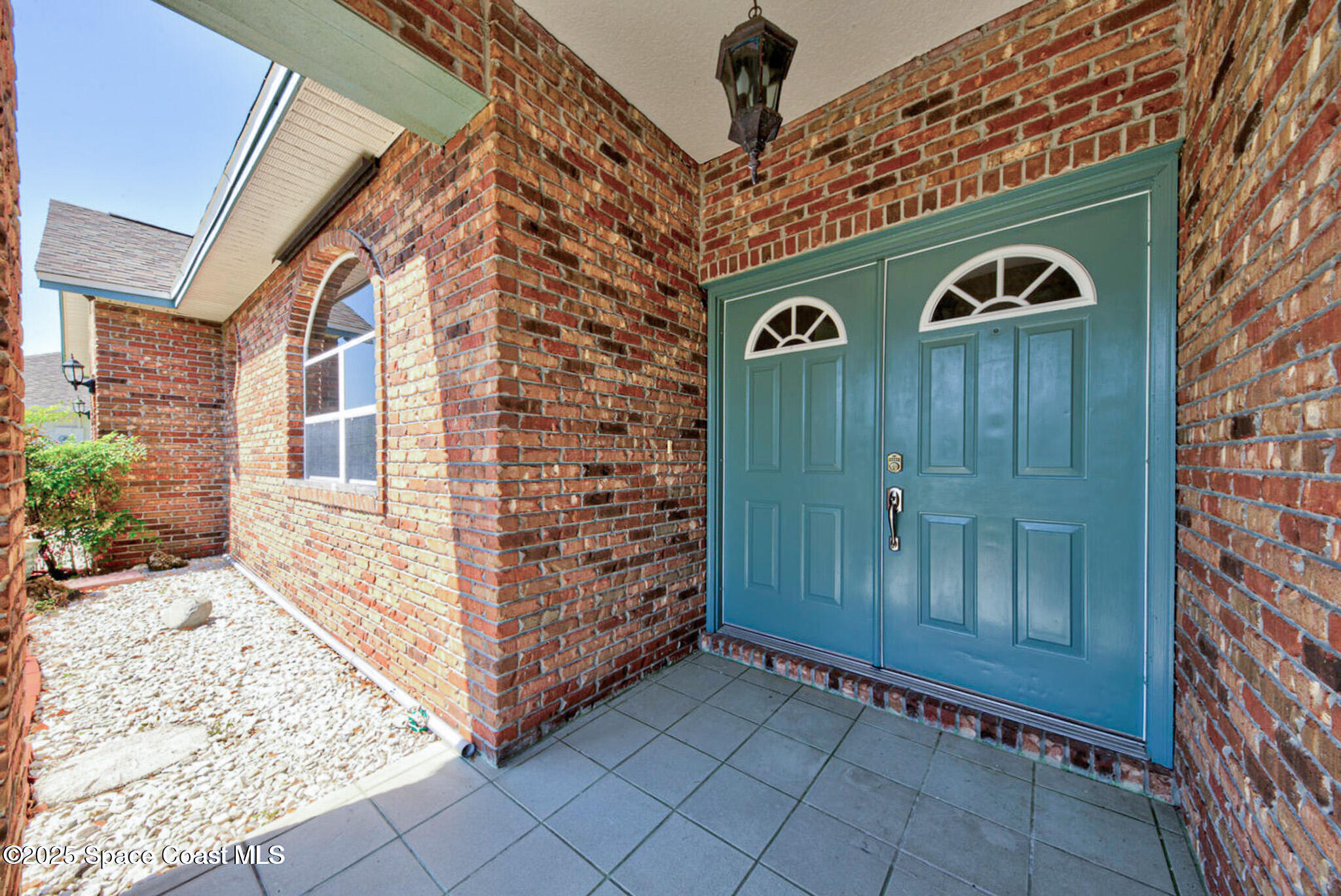 4065 Sand Ridge Drive Merritt Island, FL 32953 - Photo 6 of 59 a front view of a building with entryway