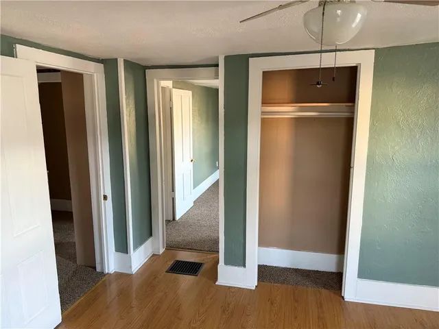 a view of a room with wooden floor