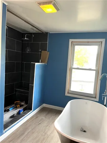 a bathroom with a tub and a window