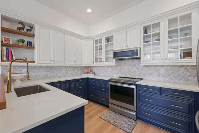 a kitchen with stainless steel appliances granite countertop a refrigerator and a stove