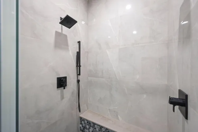 a spacious bedroom with a bed and a large window