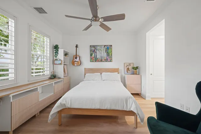 a bedroom with a bed couch and a large window