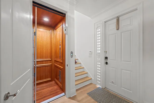 a view of a hallway with wooden floor and entryway