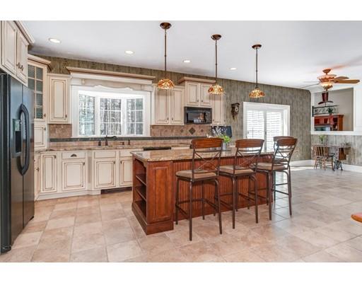 45 Chapin Road Holden, MA 01520 - Photo 9 of 28 a open kitchen with stainless steel appliances granite countertop a stove top oven a refrigerator a dining table and chairs with wooden floor