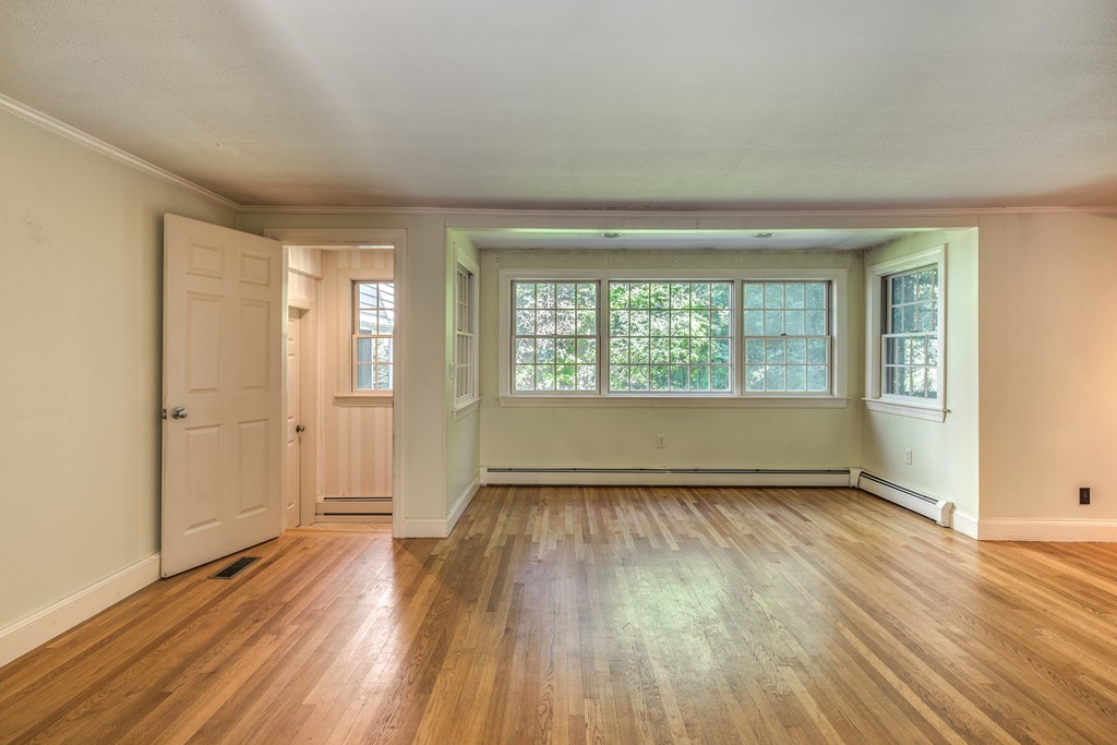 34 Leslie Road Winchester, MA 01890 - Photo 14 of 26 an empty room with wooden floor and windows