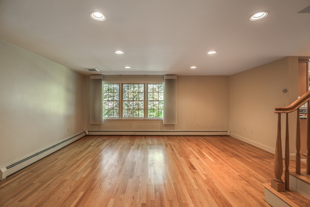 34 Leslie Road Winchester, MA 01890 - Photo 17 of 26 an empty room with wooden floor and windows