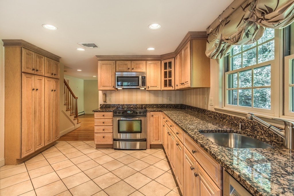 34 Leslie Road Winchester, MA 01890 - Photo 20 of 26 a kitchen with stainless steel appliances granite countertop a sink stove and refrigerator