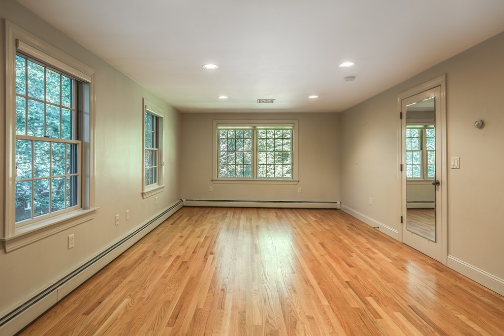 34 Leslie Road Winchester, MA 01890 - Photo 21 of 26 an empty room with wooden floor and windows