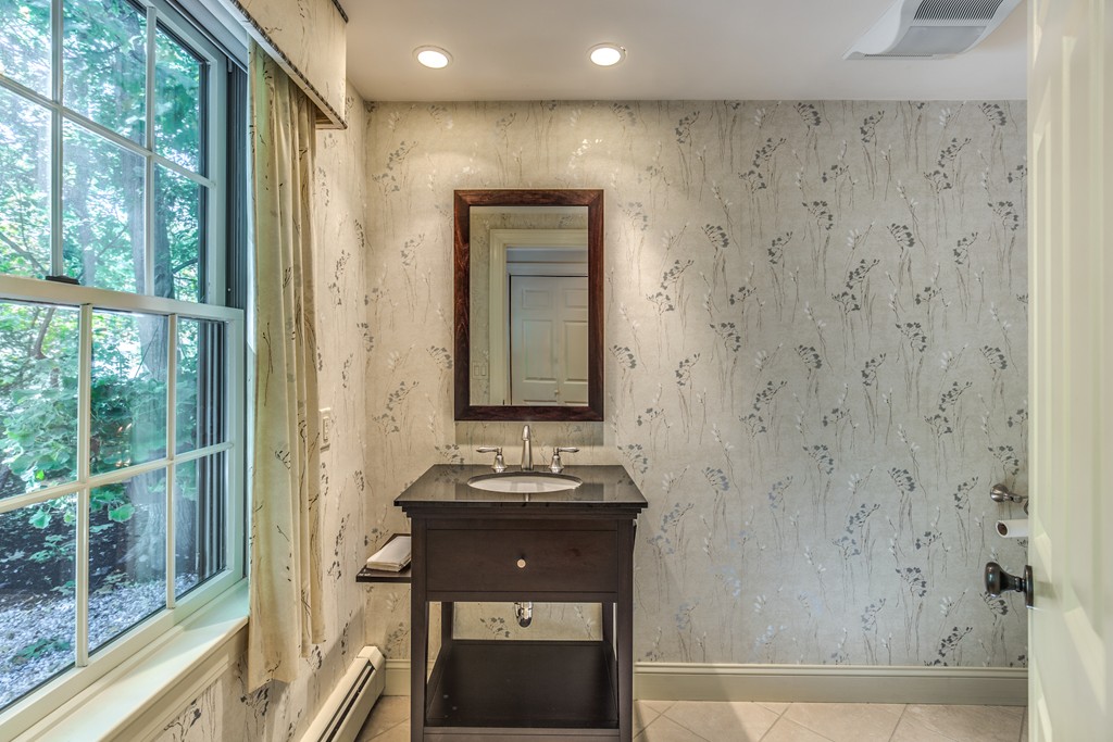 34 Leslie Road Winchester, MA 01890 - Photo 23 of 26 a bathroom with a sink a mirror and a shower