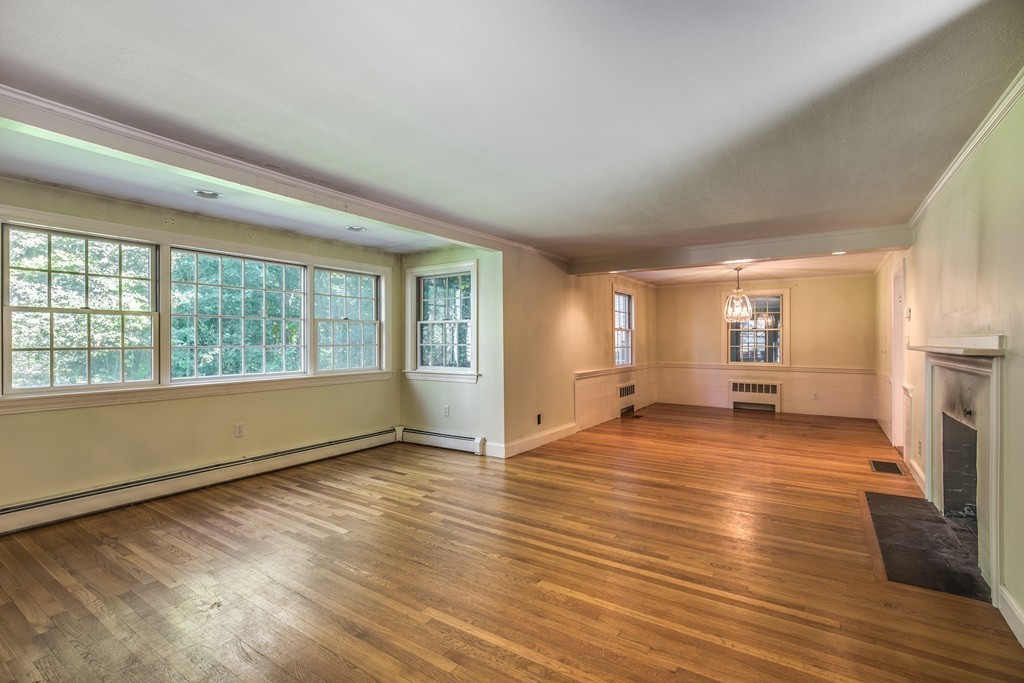 34 Leslie Road Winchester, MA 01890 - Photo 5 of 26 a view of empty room with wooden floor and fireplace