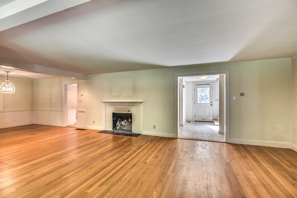 34 Leslie Road Winchester, MA 01890 - Photo 6 of 26 a view of empty room with wooden floor and fireplace