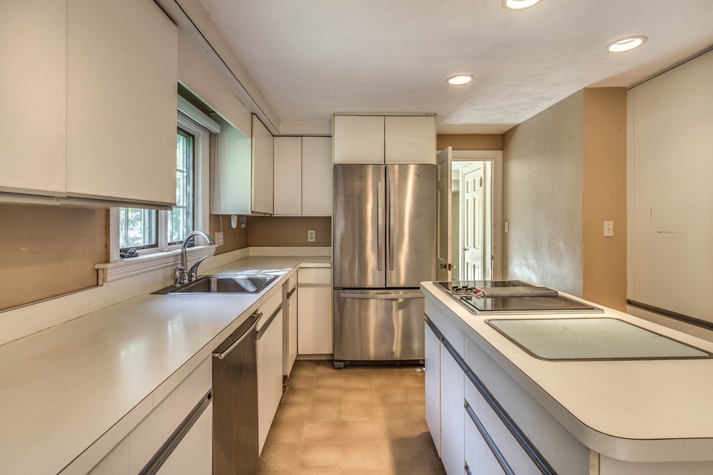 34 Leslie Road Winchester, MA 01890 - Photo 8 of 26 a kitchen with a sink stove and refrigerator