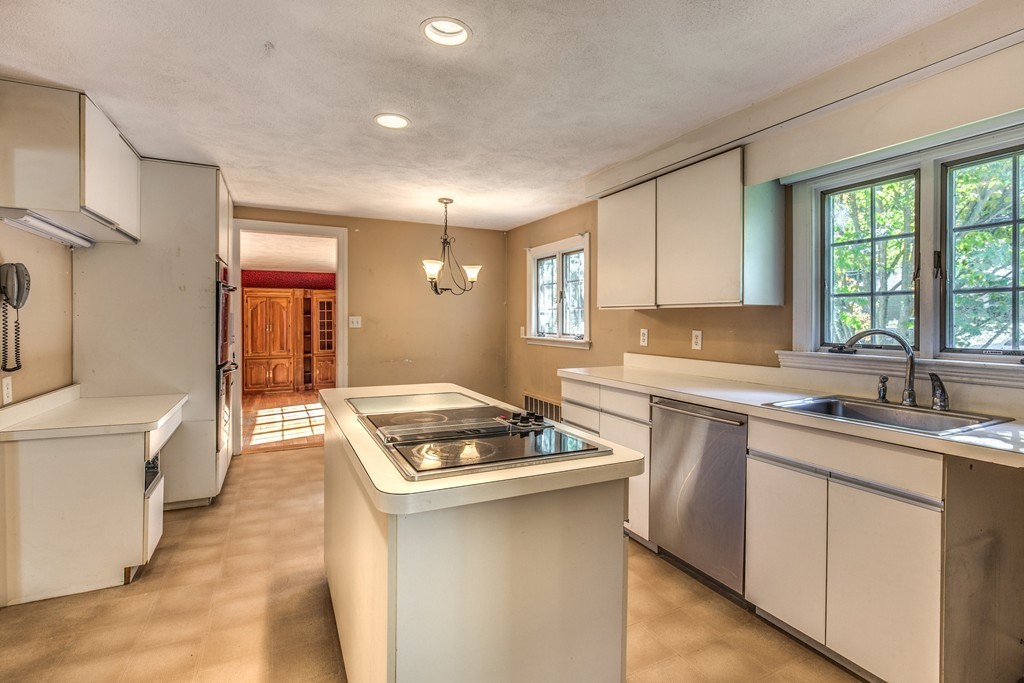 34 Leslie Road Winchester, MA 01890 - Photo 9 of 26 a kitchen with stainless steel appliances granite countertop a sink stove and cabinets