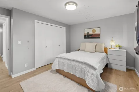 a bedroom with a bed and a painting on the wall