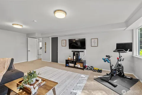 a bedroom with furniture and a flat screen tv