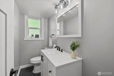 a bathroom with a sink toilet and a mirror