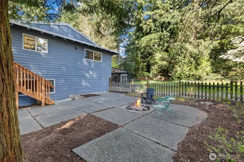a view of a chair and table in the back yard