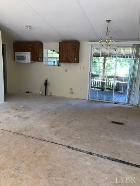 341 Broad Ridge Road Sandy Level, VA 24161 - Photo 12 of 16 a view of a livingroom with an empty space and a window