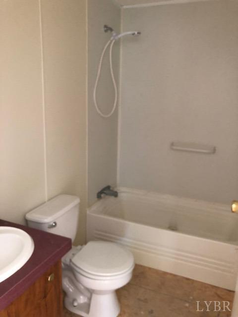341 Broad Ridge Road Sandy Level, VA 24161 - Photo 16 of 16 a white toilet sitting next to a bath tub and a shower