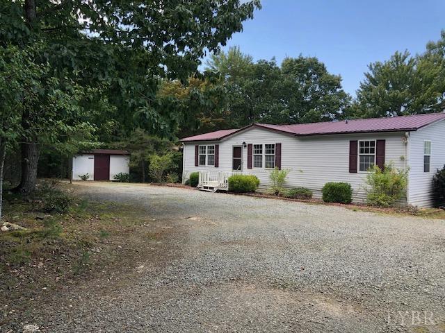 341 Broad Ridge Road Sandy Level, VA 24161 - Photo 3 of 16 a front view of a house with a yard and garage