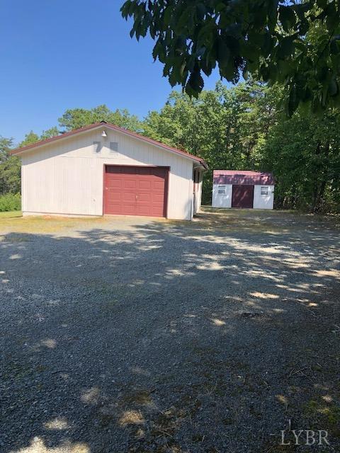 341 Broad Ridge Road Sandy Level, VA 24161 - Photo 6 of 16 a front view of a house with a yard and garage