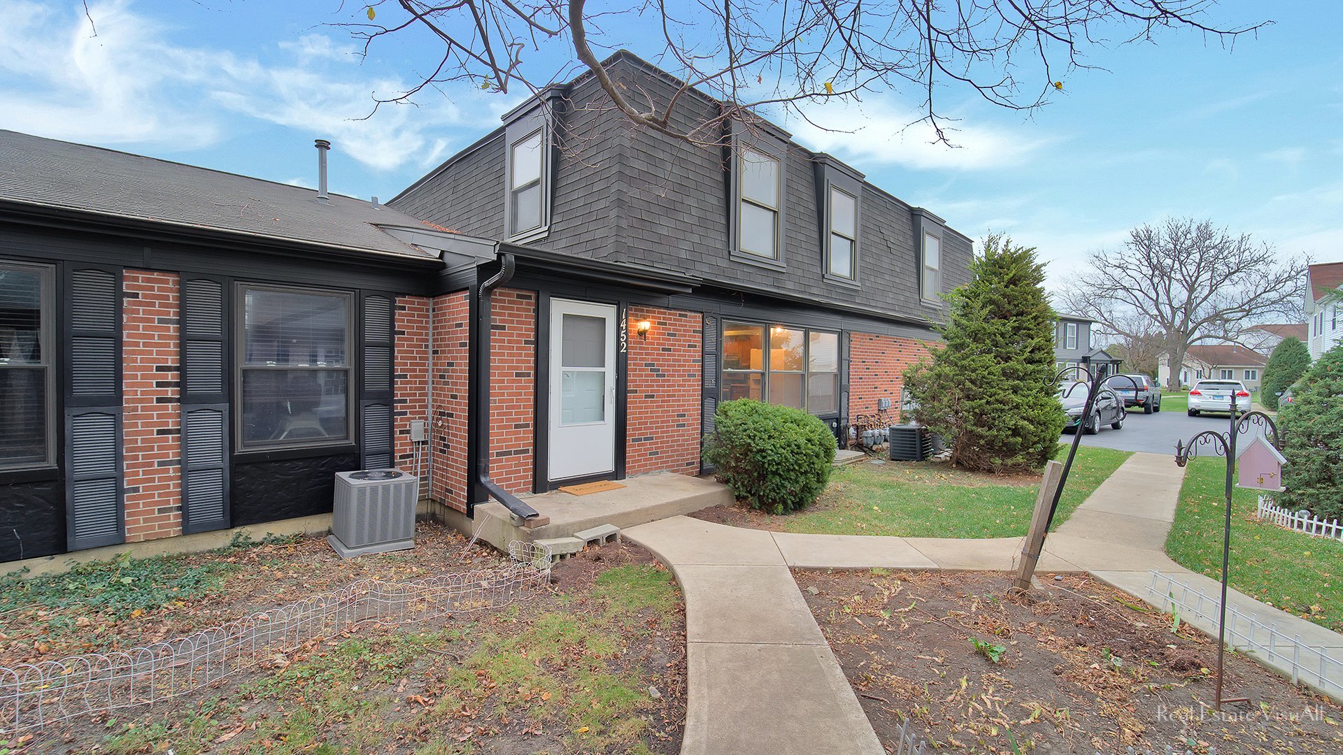 a front view of a house with a yard outdoor seating and barbeque oven