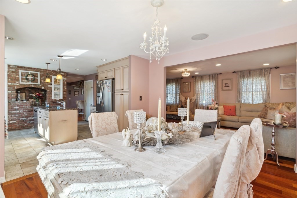 49 Dibble Road Lynn, MA 01904 - Photo 11 of 41 a view of a dining room and livingroom with furniture wooden floor a chandelier