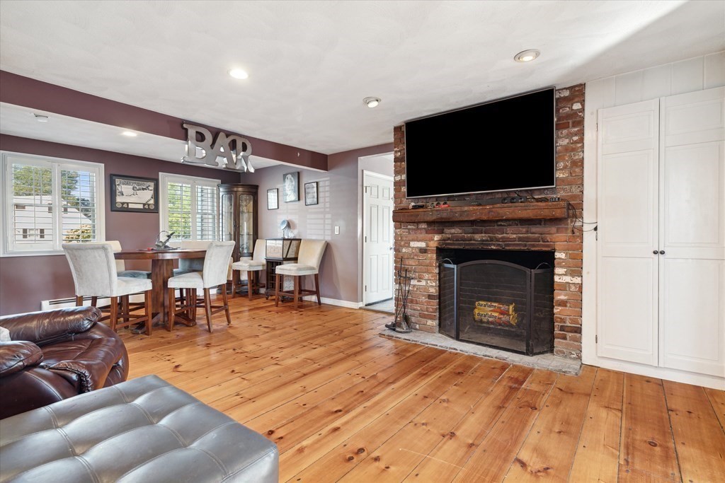 49 Dibble Road Lynn, MA 01904 - Photo 12 of 41 a living room with furniture a flat screen tv and a fireplace