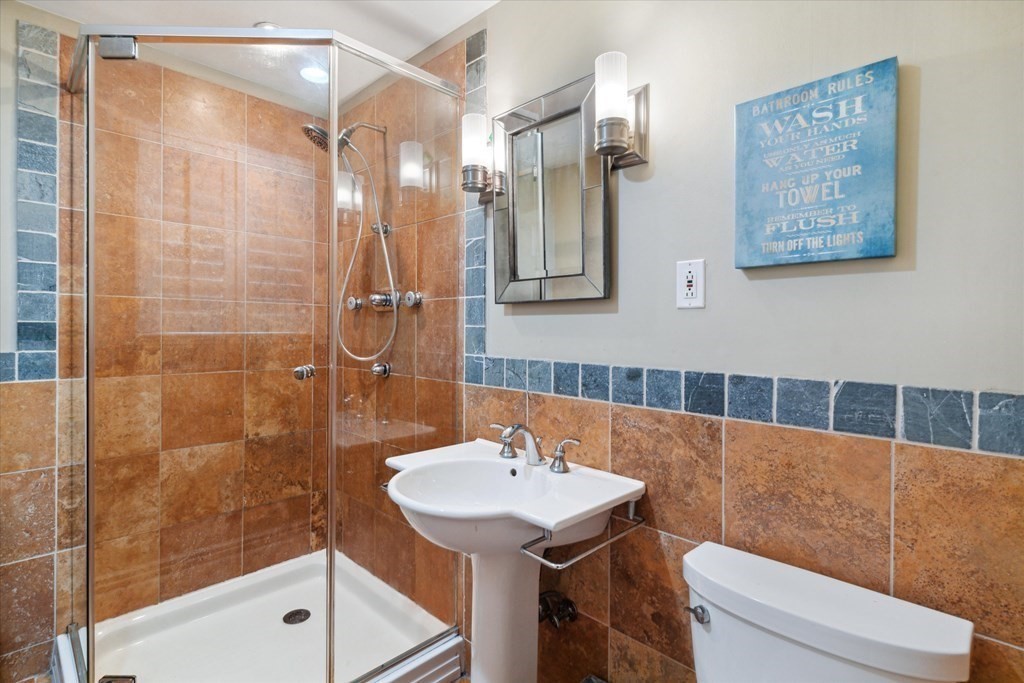 49 Dibble Road Lynn, MA 01904 - Photo 15 of 41 a bathroom with a sink a toilet a shower and a mirror