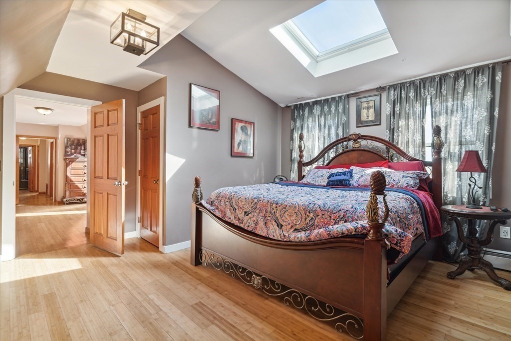 49 Dibble Road Lynn, MA 01904 - Photo 19 of 41 a bedroom with a large bed and a chandelier