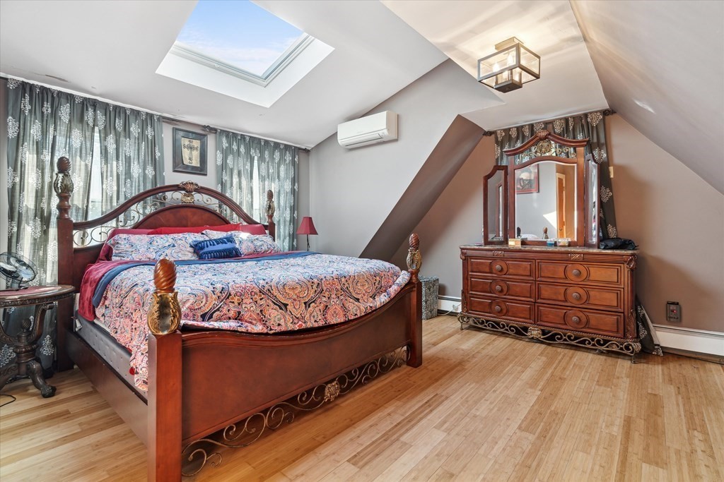 49 Dibble Road Lynn, MA 01904 - Photo 20 of 41 a bed sitting in a room next to a wooden floor