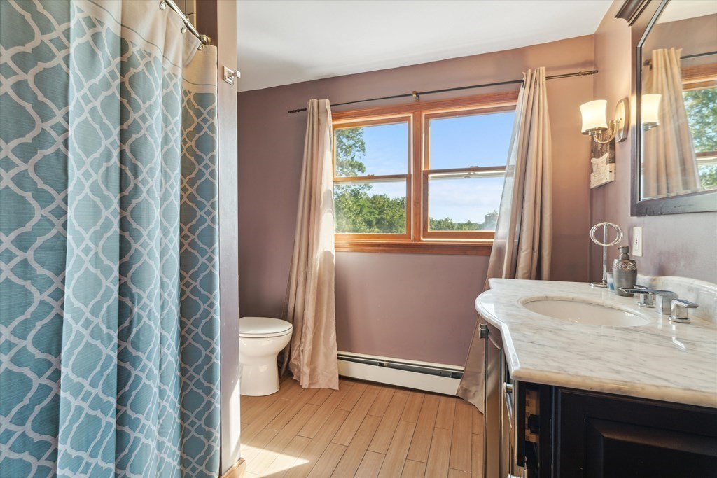 49 Dibble Road Lynn, MA 01904 - Photo 22 of 41 a bathroom with a granite countertop sink toilet and a mirror