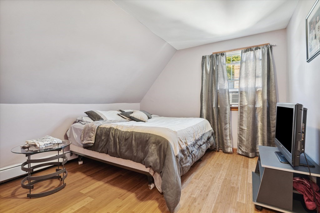 49 Dibble Road Lynn, MA 01904 - Photo 24 of 41 a bedroom with a bed and a flat tv screen on a dresser