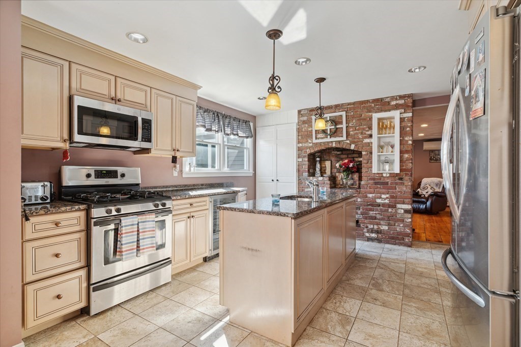 49 Dibble Road Lynn, MA 01904 - Photo 5 of 41 a kitchen with stainless steel appliances granite countertop a stove and cabinets