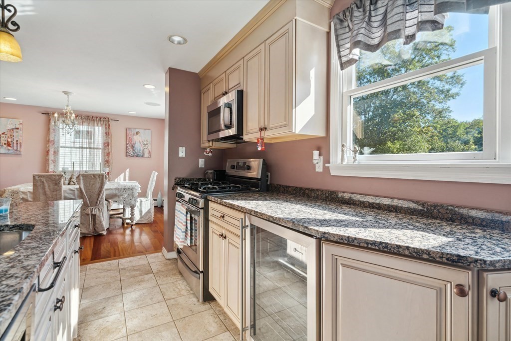 49 Dibble Road Lynn, MA 01904 - Photo 6 of 41 a kitchen with stainless steel appliances granite countertop a stove a sink and a microwave