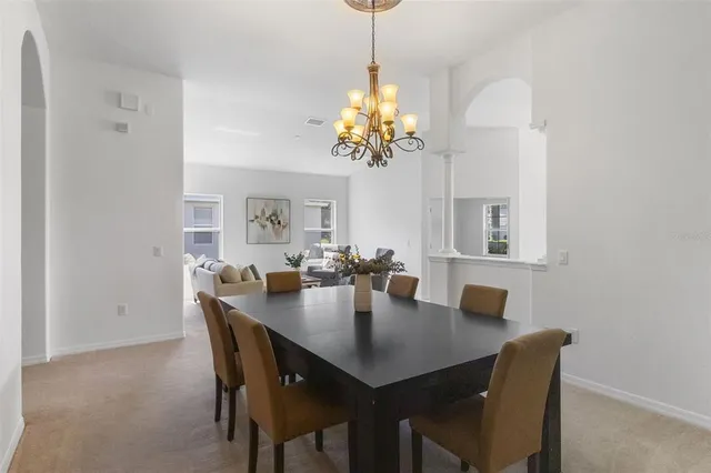 a living room with furniture a lamp and a potted plant