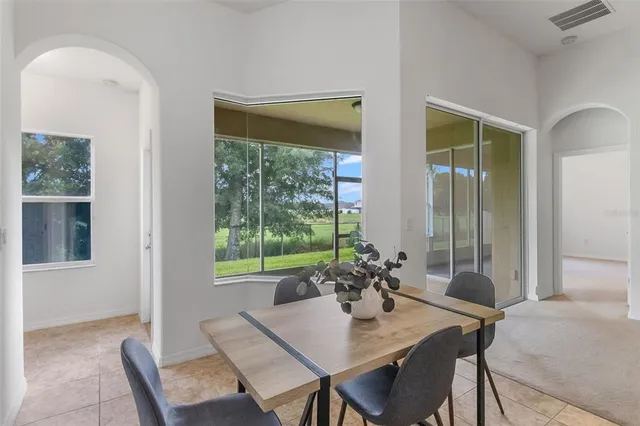 a kitchen with stainless steel appliances granite countertop a refrigerator a stove and a sink with wooden floor