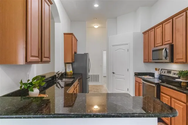 a kitchen with a sink stove and cabinets