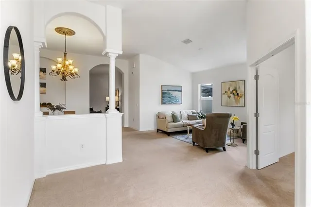a living room with furniture and painting on the wall