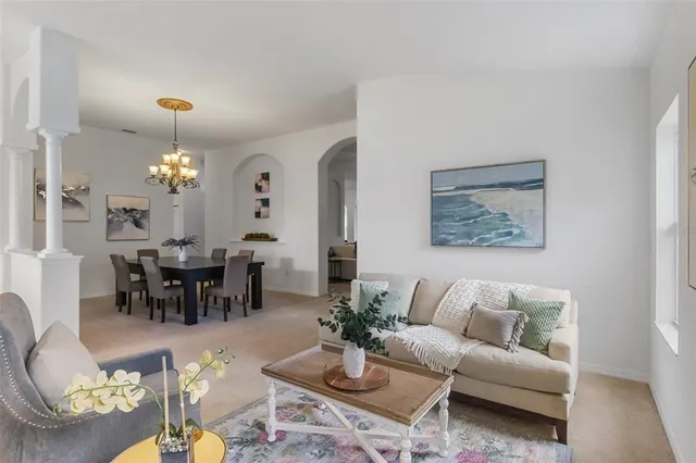 a view of a dining room with furniture and chandelier