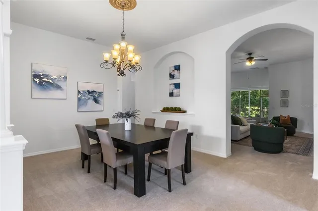 a view of a dining room with a table and chairs